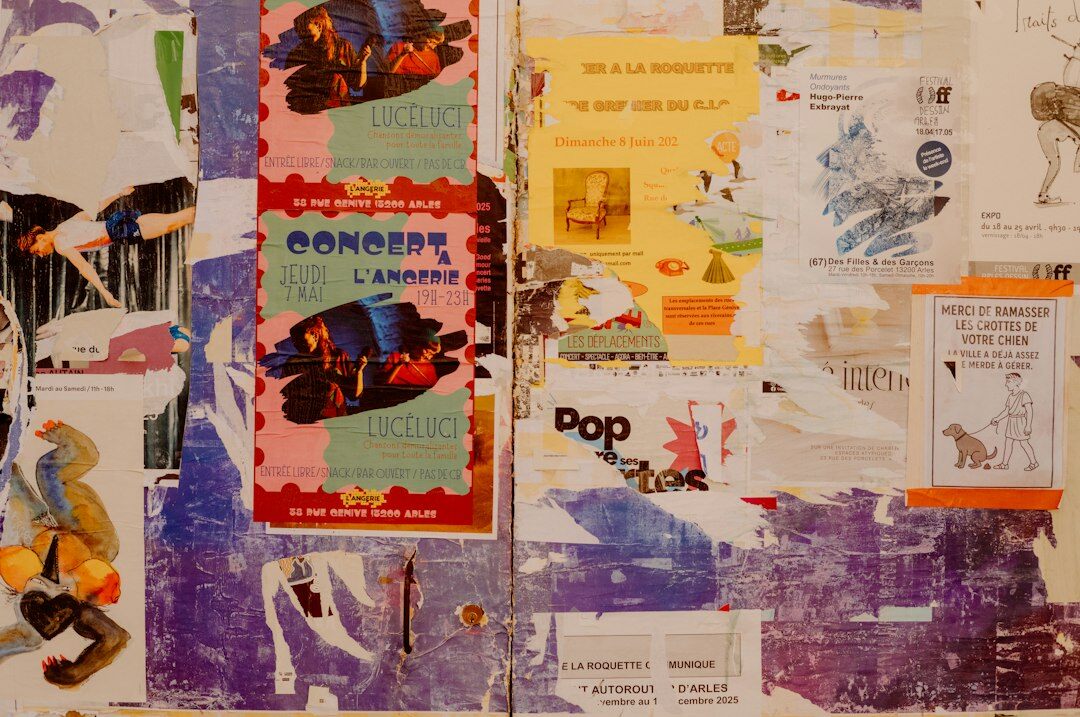 Wall covered with layers of old advertising posters from past decades